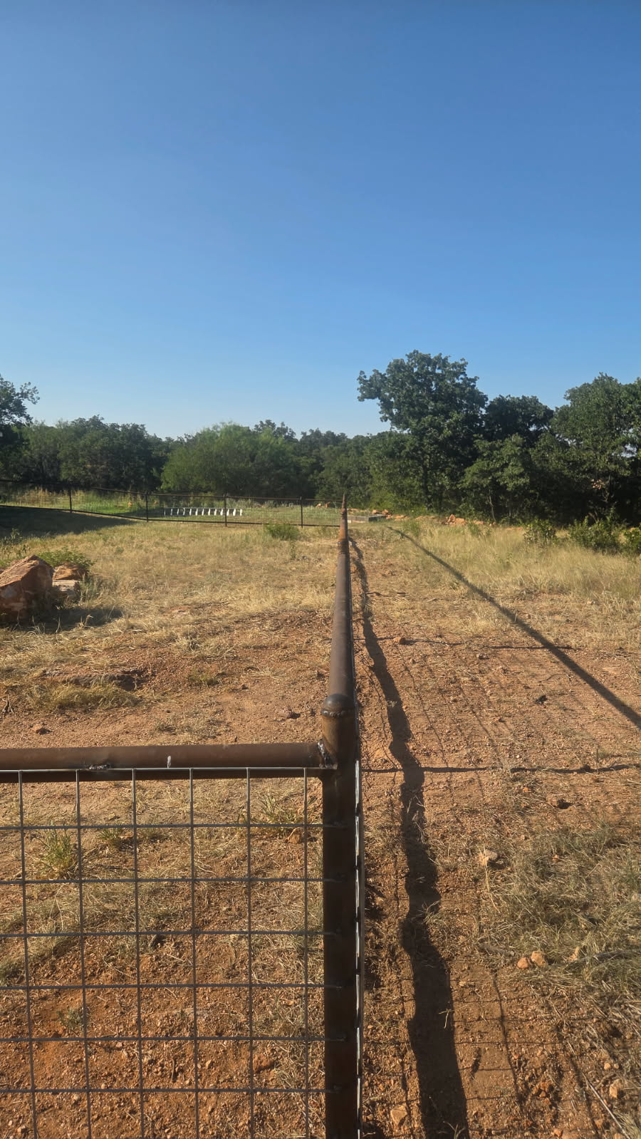Welded corner and end-post detail on a 2-rail pipe and wire-panel fence