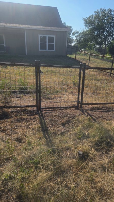 Custom walk-through gate matched to a pipe fence with 4x4 wire panels