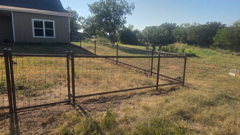 Custom welded gate and 2-rail pipe fence with 4x4 wire panels