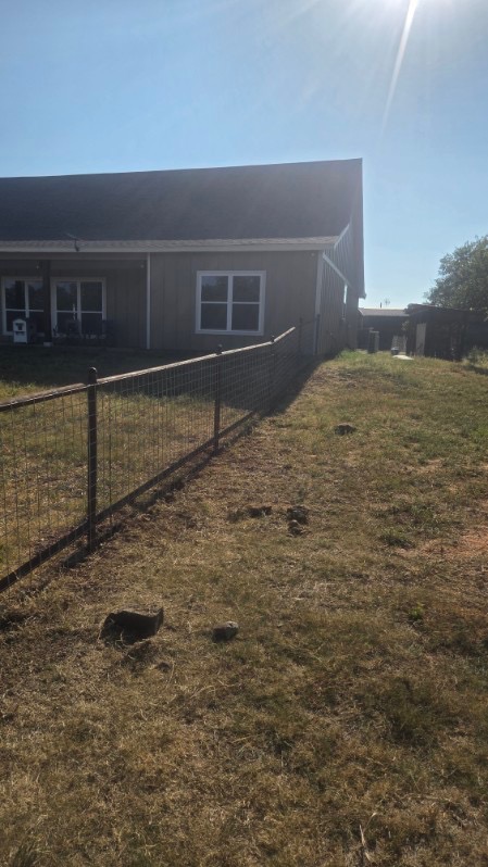 Straight side-yard run of 2-rail pipe fence with wire panels