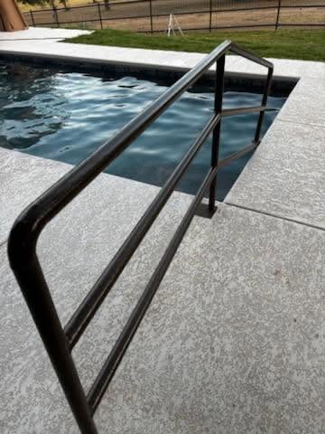 Welded pool handrail detail showing clean custom welding in Texas