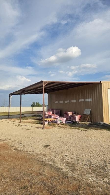 Steel loafing shed providing livestock shade on a Texas ranch