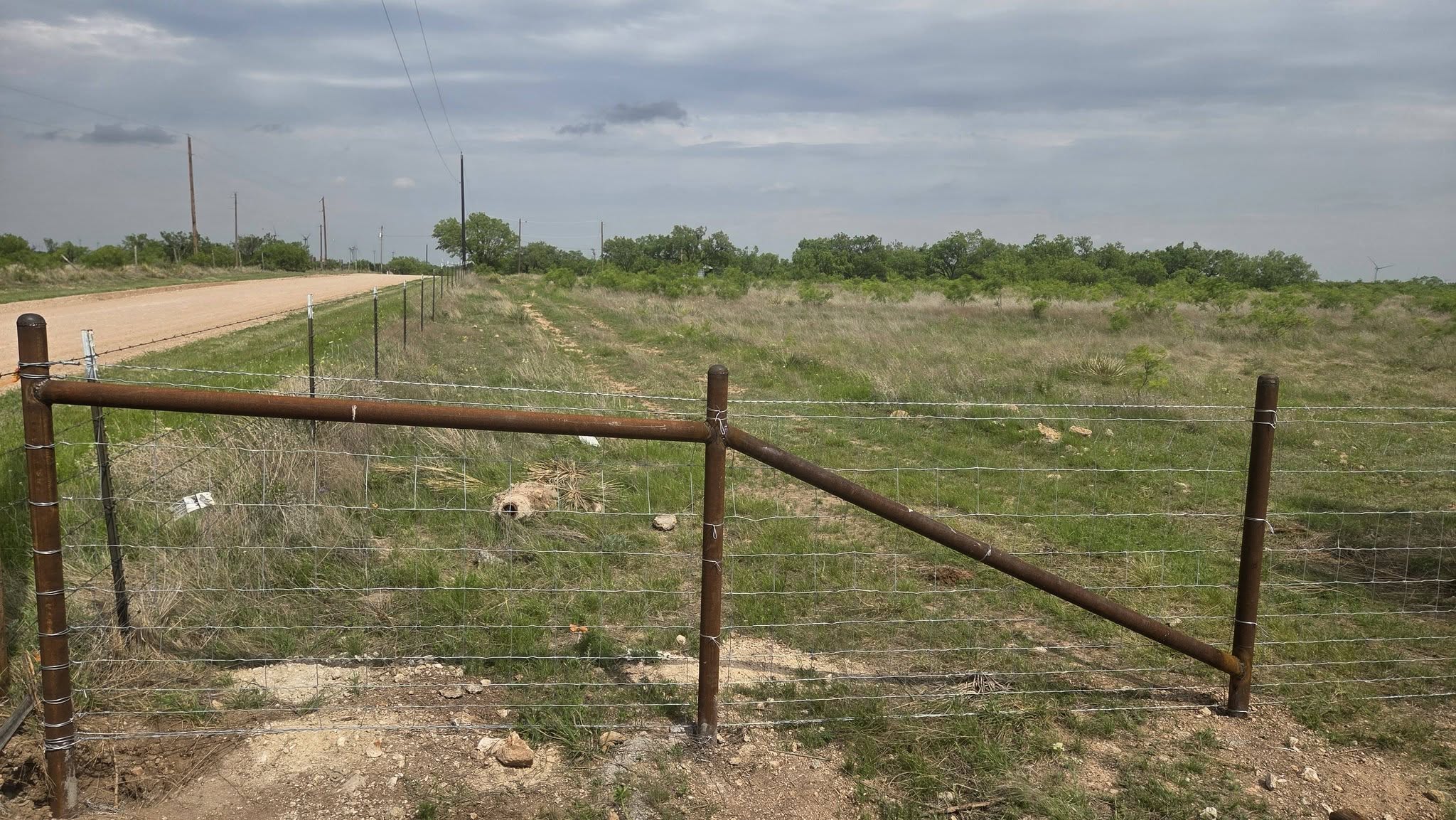 Barbwire and pipe ranch fence line in West Texas