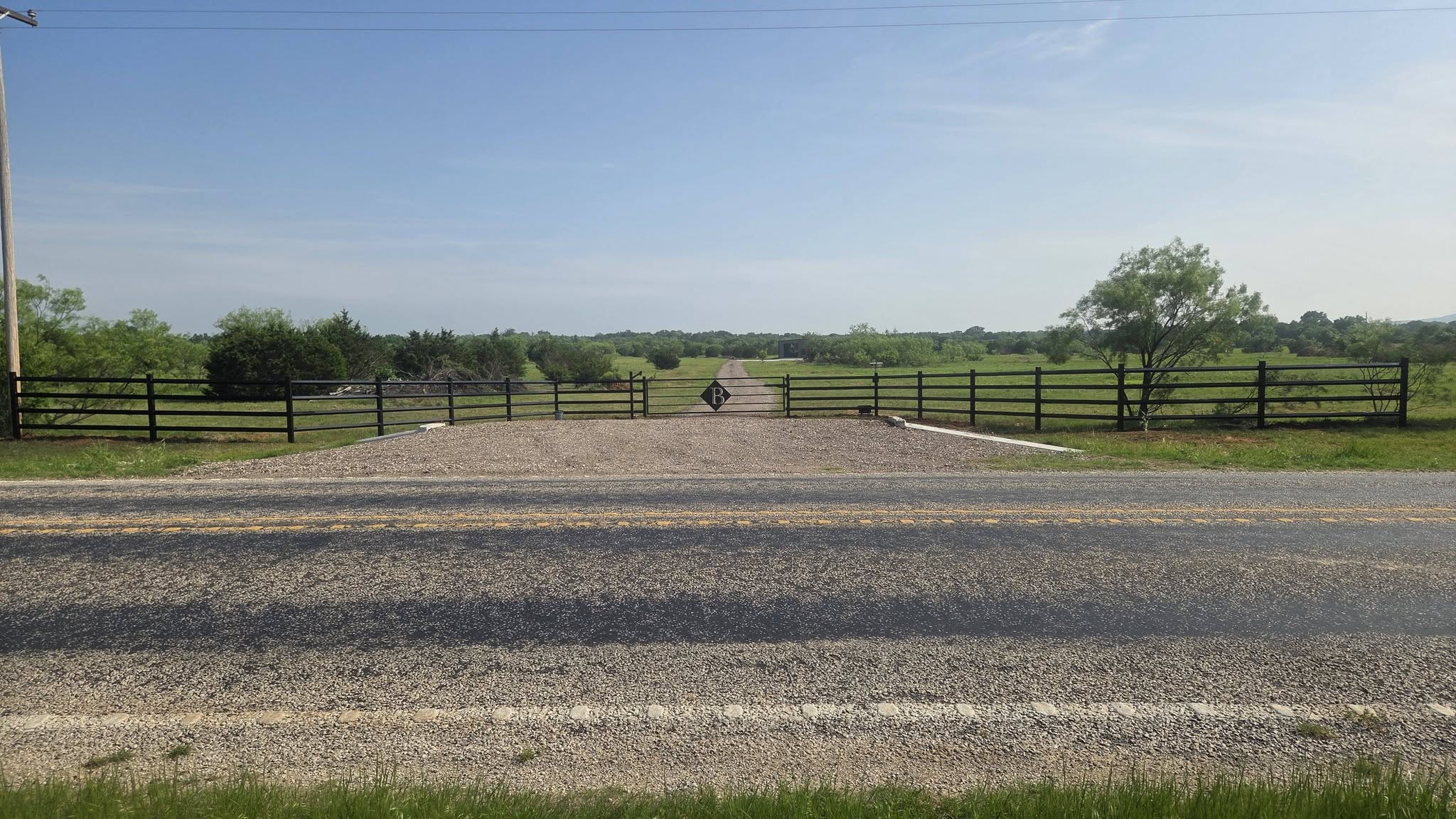 Ranch entrance gate with a cattle guard installed in Central Texas