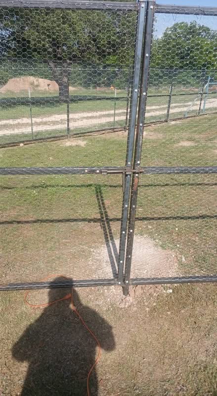 Close view of reinforced steel panels and poultry wire on a custom chicken enclosure