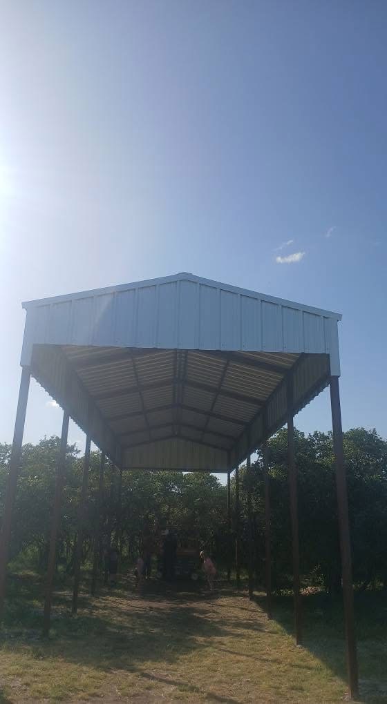 Finished freestanding metal RV cover with tall clearance and open sides in Texas