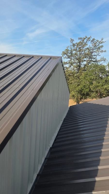 Finished metal roof valley and vertical wall panels on a Texas building addition