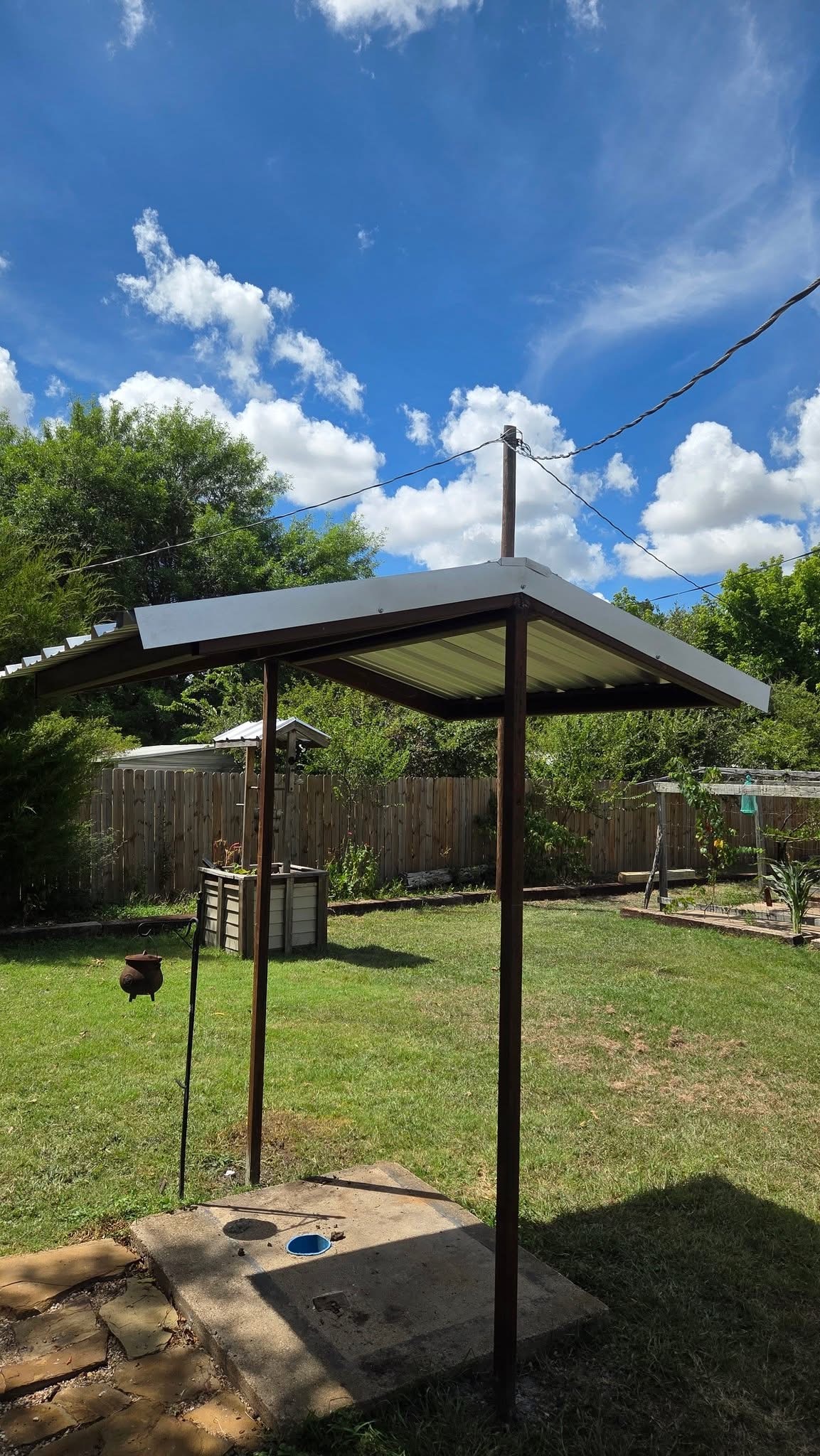 Compact metal walkway awning with steel posts and finished roof panels in Texas