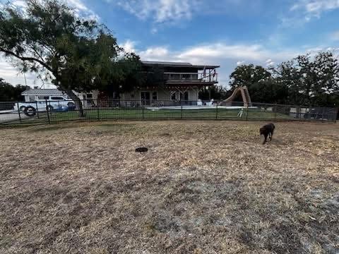 Wide view of a welded pipe and wire fence surrounding a Texas homestead