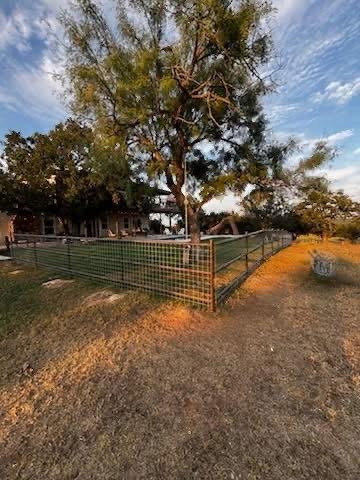 Corner view of a pipe-frame field-wire fence installed around a Texas acreage