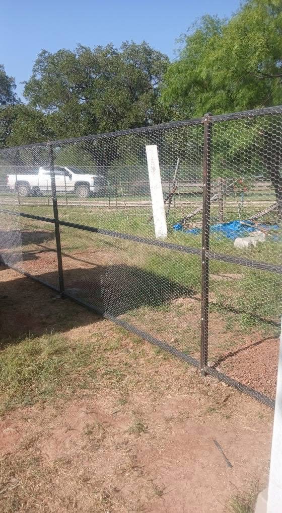 Long predator-resistant chicken run built with welded steel framing and poultry wire in Texas