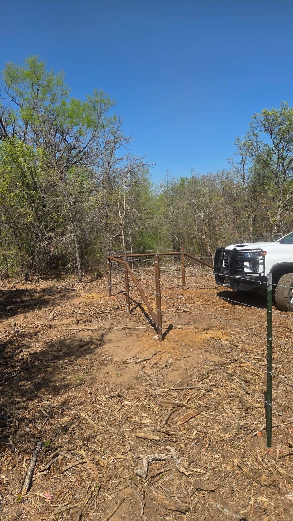 Welded ranch gate and barbed-wire brace built for a wooded Texas property