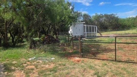 Steel wire-panel ranch gate installed between welded posts on a Texas property