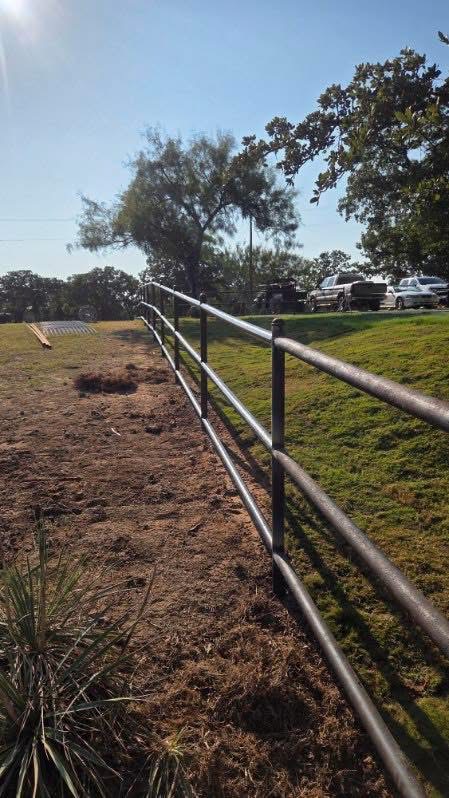 Welded three-rail pipe fence installed on a sloped Texas property