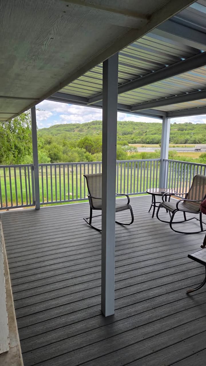 Scenic covered metal deck with steel posts and low-maintenance deck boards